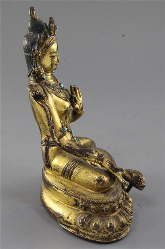 A Tibetan gilt copper alloy figure of Green Tara, 14th-15th century, height 21.3cm